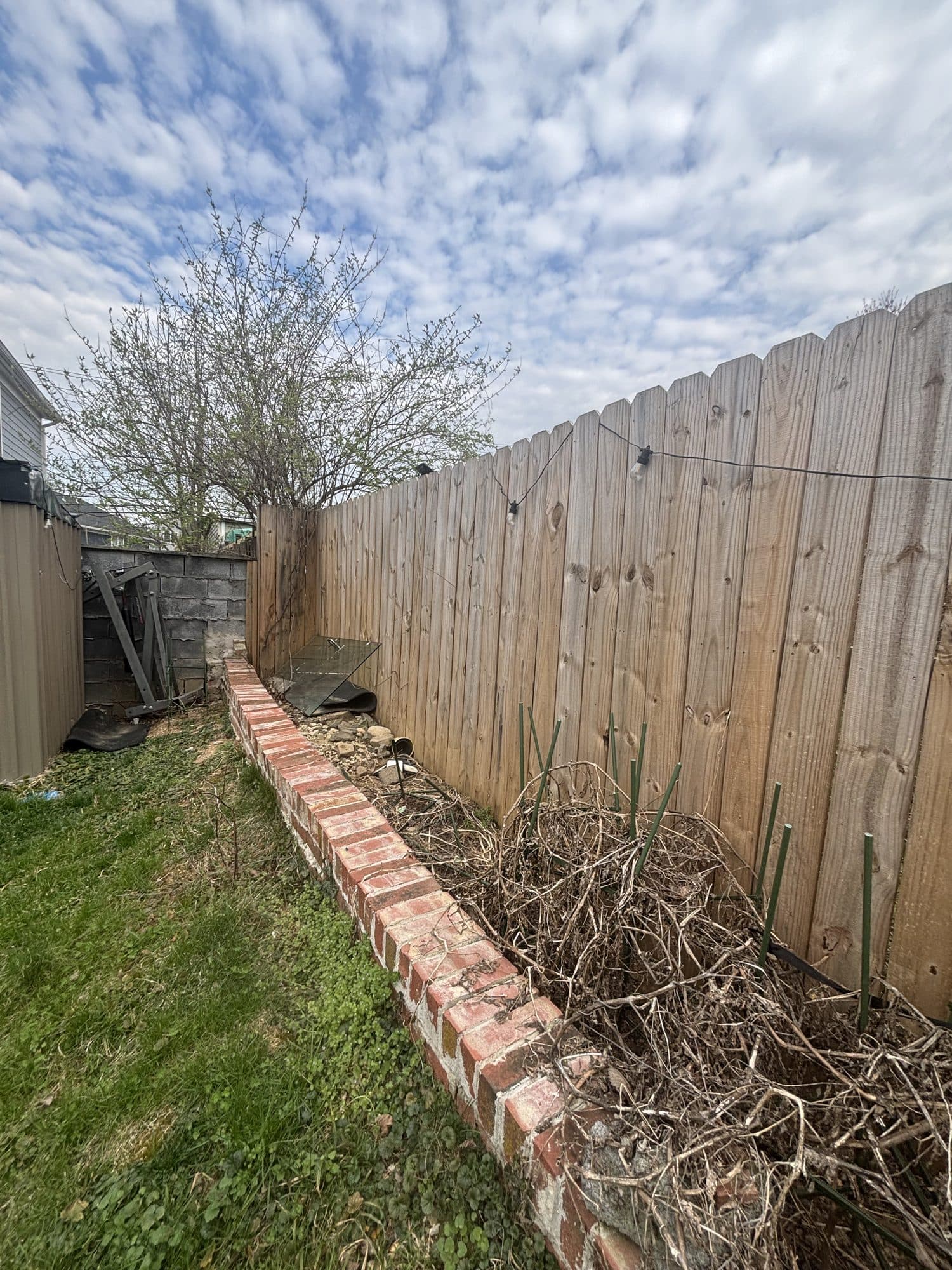Backyard wood privacy fence with brick planter. Home addition project by Potts Brothers Construction, Arlington & Northern Virginia