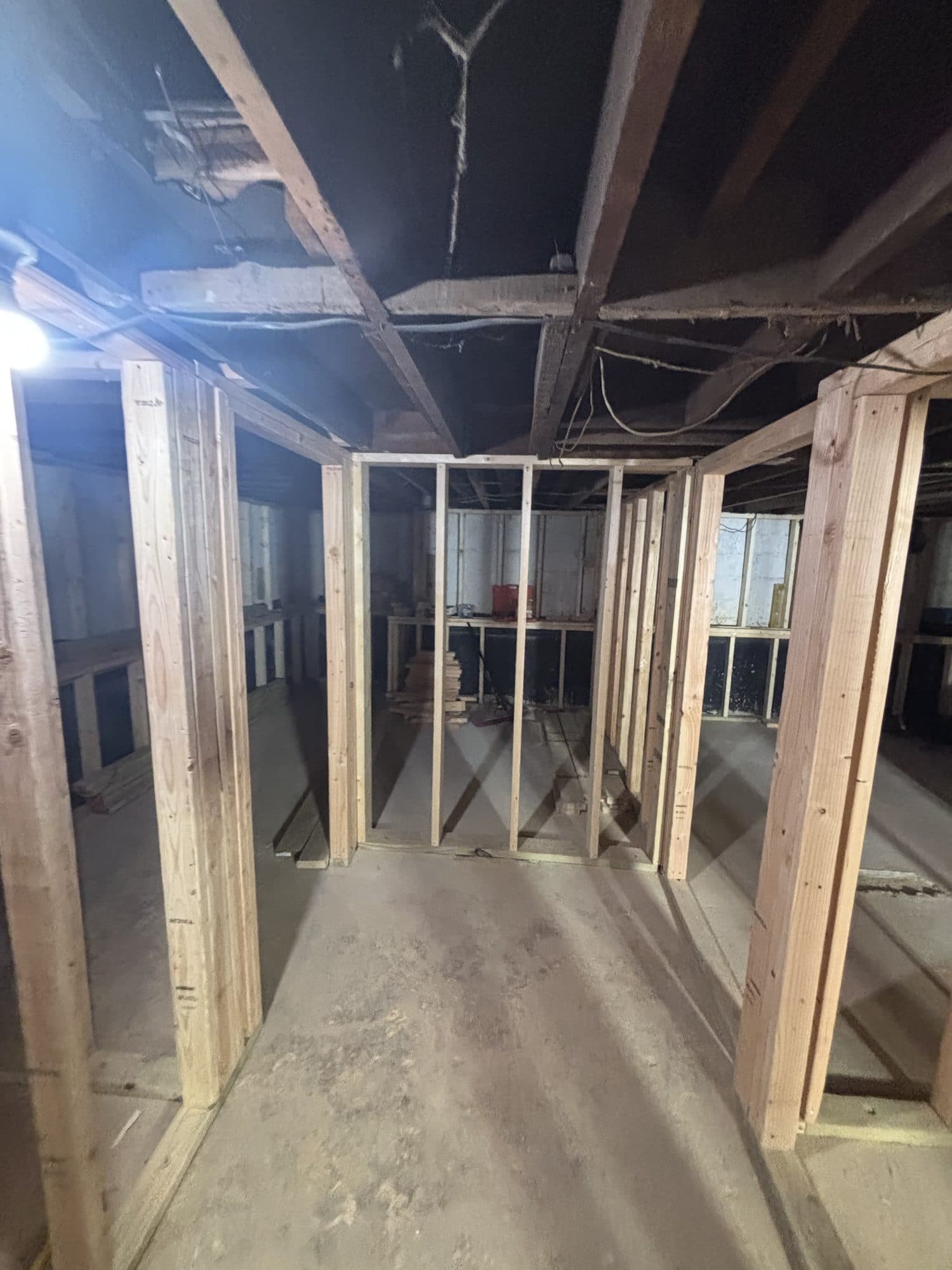 Basement framing hallway wood stud. Home addition project by Potts Brothers Construction, Arlington & Northern Virginia