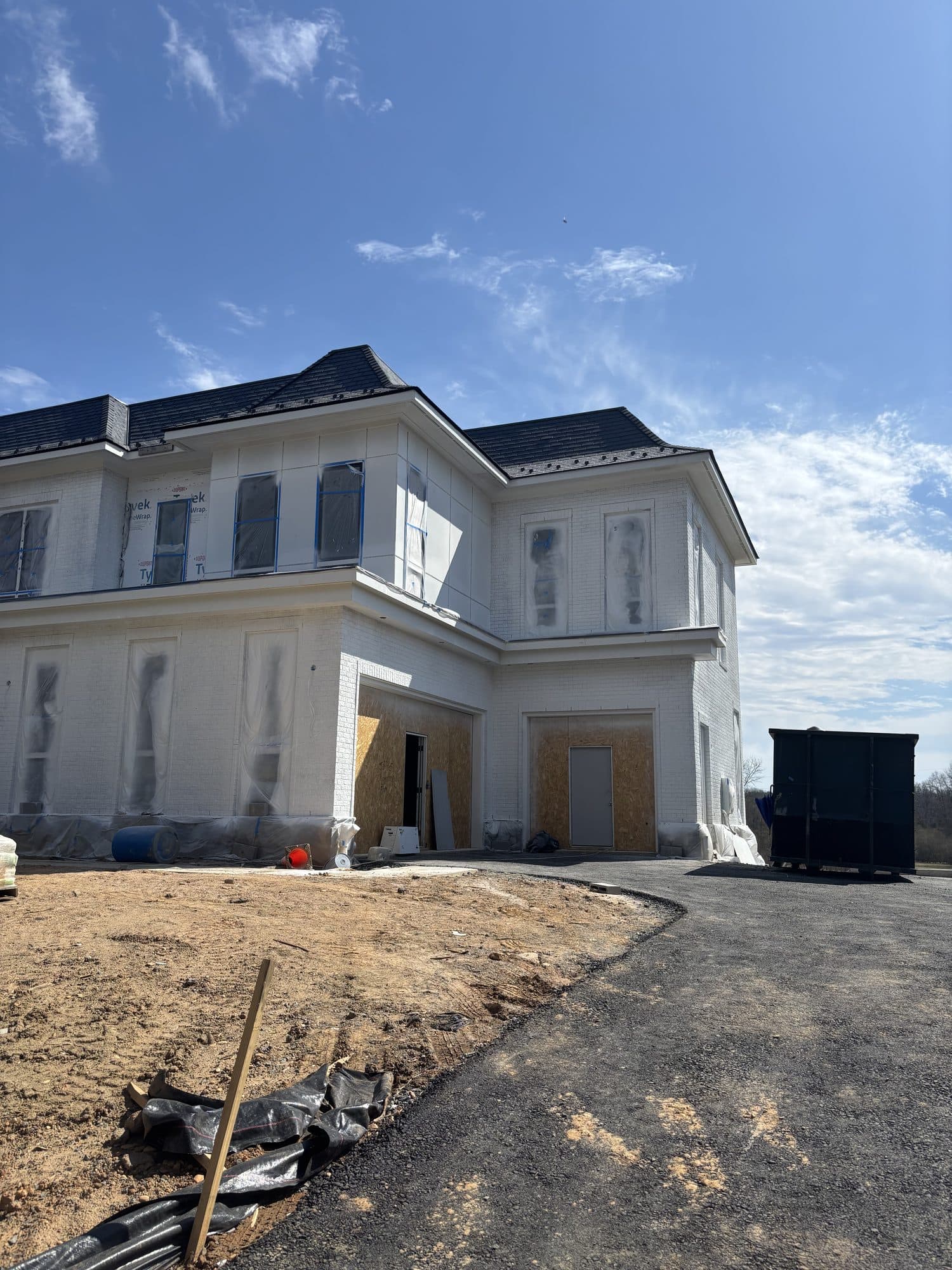 Corner of large custom home with new asphalt dri. Home addition project by Potts Brothers Construction, Arlington & Northern Virginia