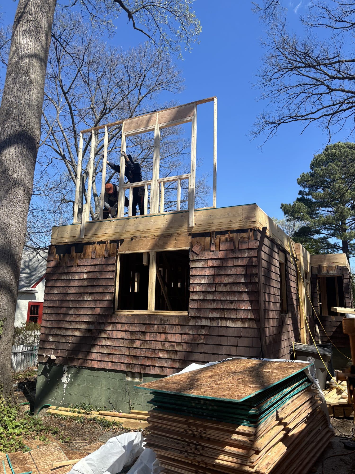 Crew framing second story addition above cedar. Home addition project by Potts Brothers Construction, Arlington & Northern Virginia