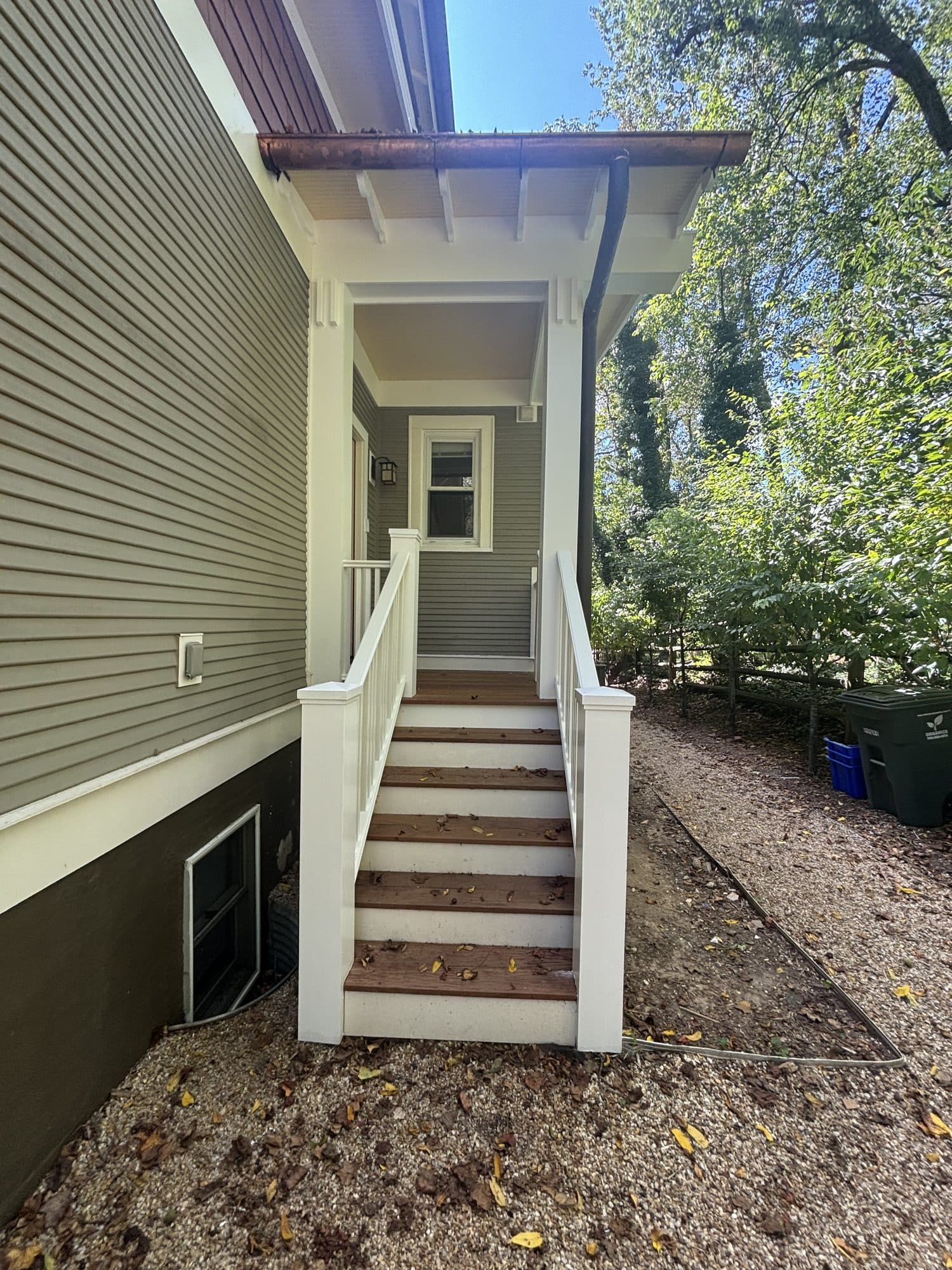 Exterior porch stairs with railing and landing. Home addition project by Potts Brothers Construction, Arlington & Northern Virginia