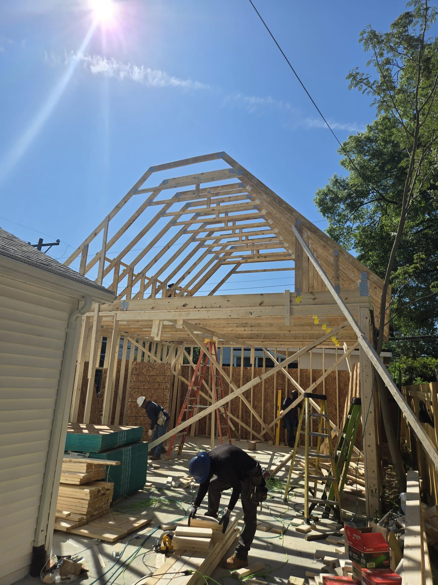 Framed addition gambrel trusses worker. Home addition project by Potts Brothers Construction, Arlington & Northern Virginia