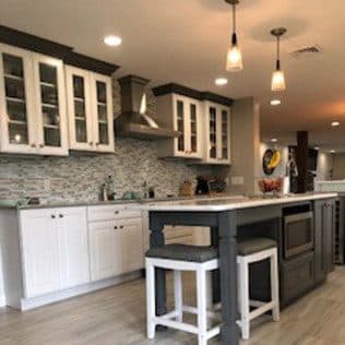 Kitchen with glass cabinets island and tile backsplash. Home addition project by Potts Brothers Construction, Arlington & Northern Virginia