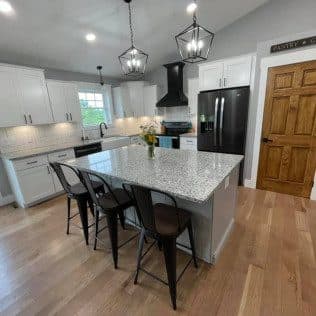 Kitchen with island, granite counters and pendant lights. Home addition project by Potts Brothers Construction, Arlington & Northern Virginia