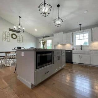 Kitchen island with microwave, dining nook and pendants. Home addition project by Potts Brothers Construction, Arlington & Northern Virginia