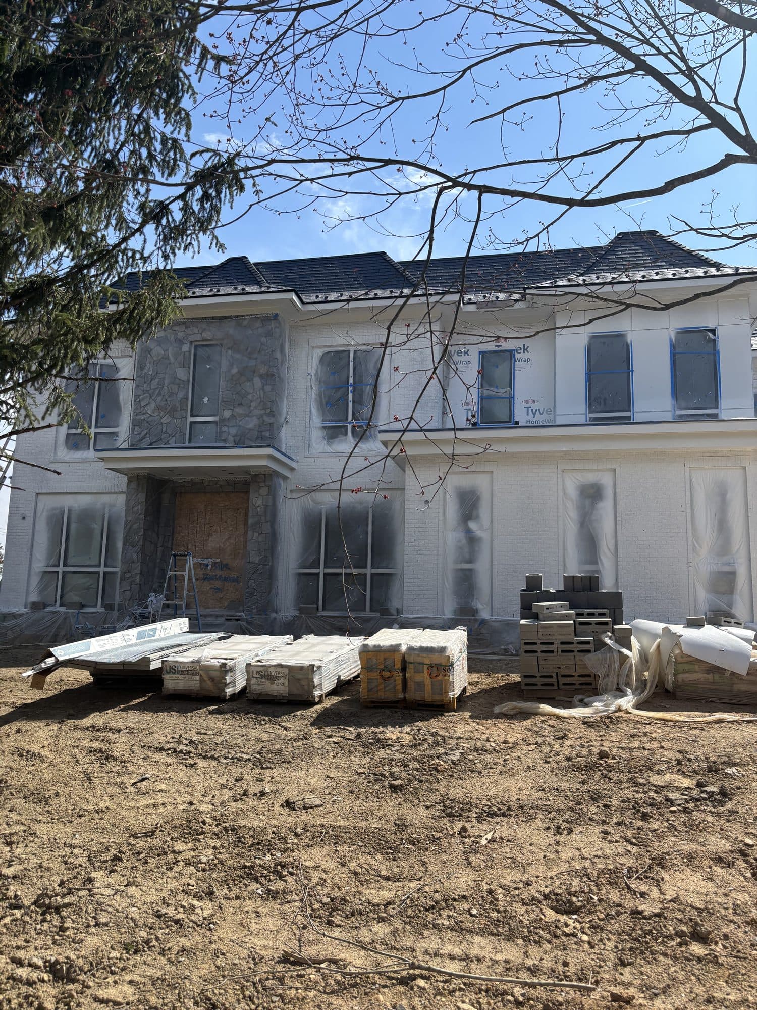 Large stucco wrapped custom home with stone entr. Home addition project by Potts Brothers Construction, Arlington & Northern Virginia