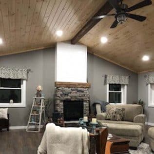 Living room with vaulted wood ceiling and stone fireplace. Home addition project by Potts Brothers Construction, Arlington & Northern Virginia