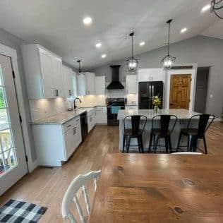 Open kitchen and dining area with vaulted ceiling. Home addition project by Potts Brothers Construction, Arlington & Northern Virginia