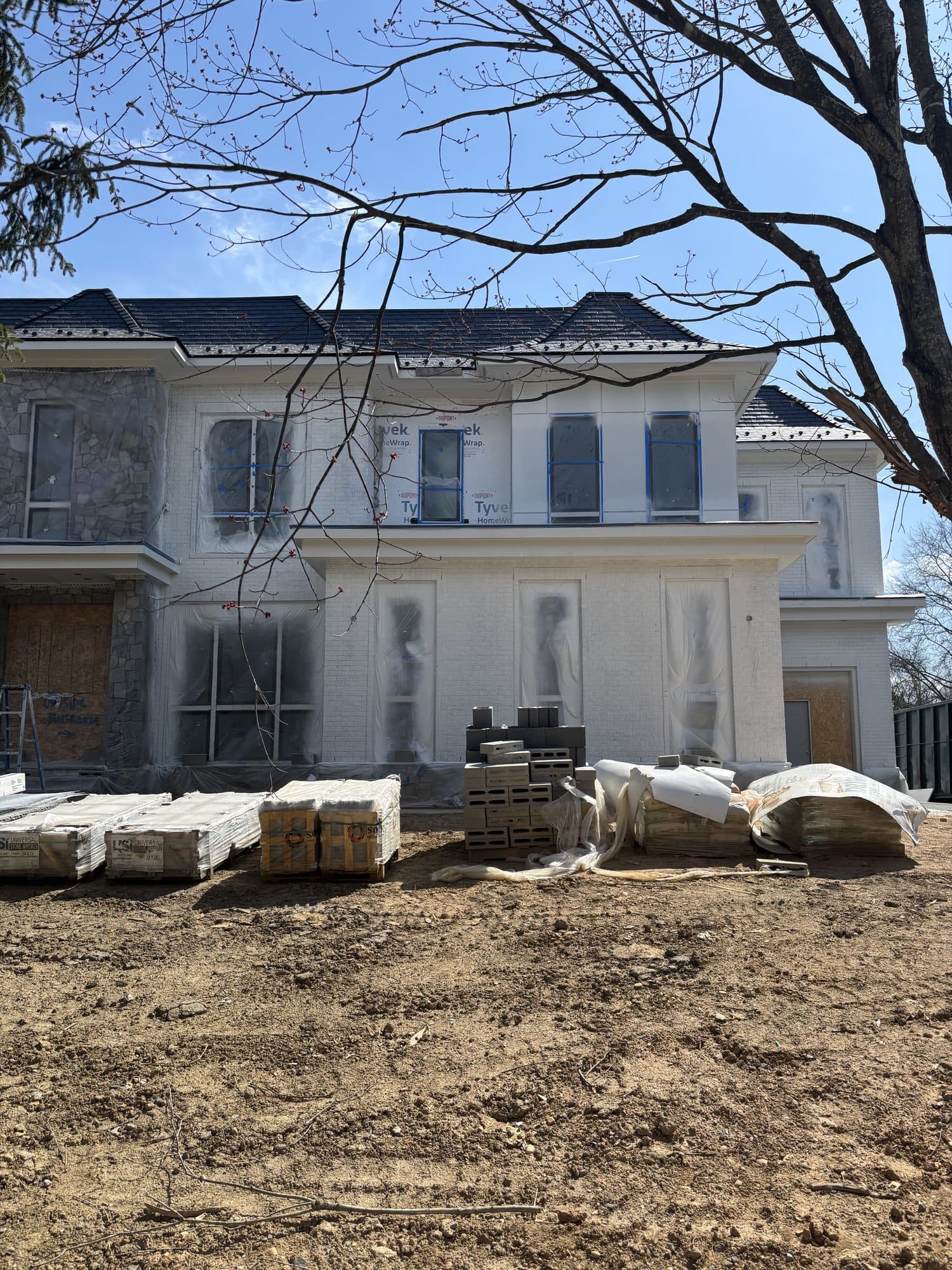 Rear elevation of large custom home wrapped for. Home addition project by Potts Brothers Construction, Arlington & Northern Virginia