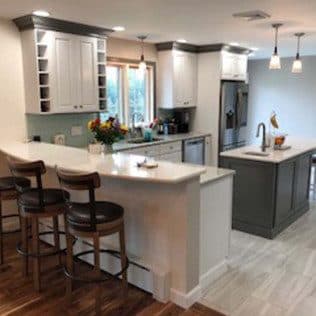 Renovated kitchen with peninsula and gray island. Home addition project by Potts Brothers Construction, Arlington & Northern Virginia