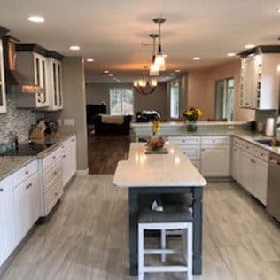 Spacious remodeled kitchen with central island and recessed lighting. Home addition project by Potts Brothers Construction, Arlington & Northern Virginia