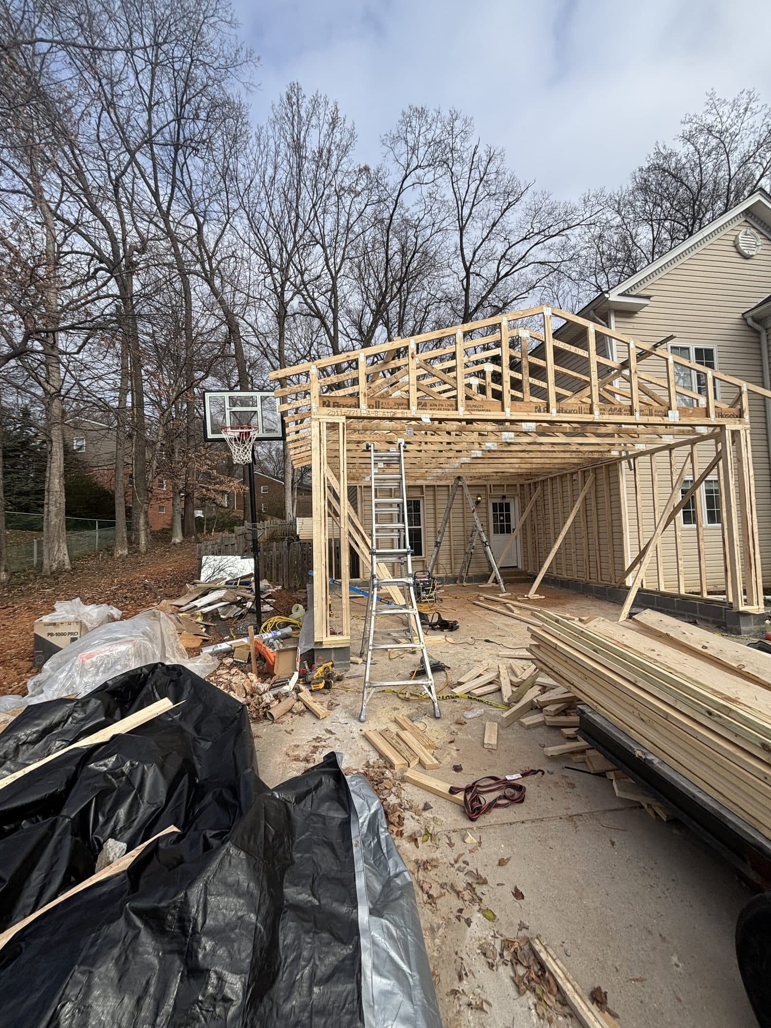 Two story addition framing under blue sky. Home addition project by Potts Brothers Construction, Arlington & Northern Virginia