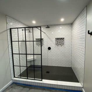 Walk-in subway tile shower with decorative tile niche. Home addition project by Potts Brothers Construction, Arlington & Northern Virginia