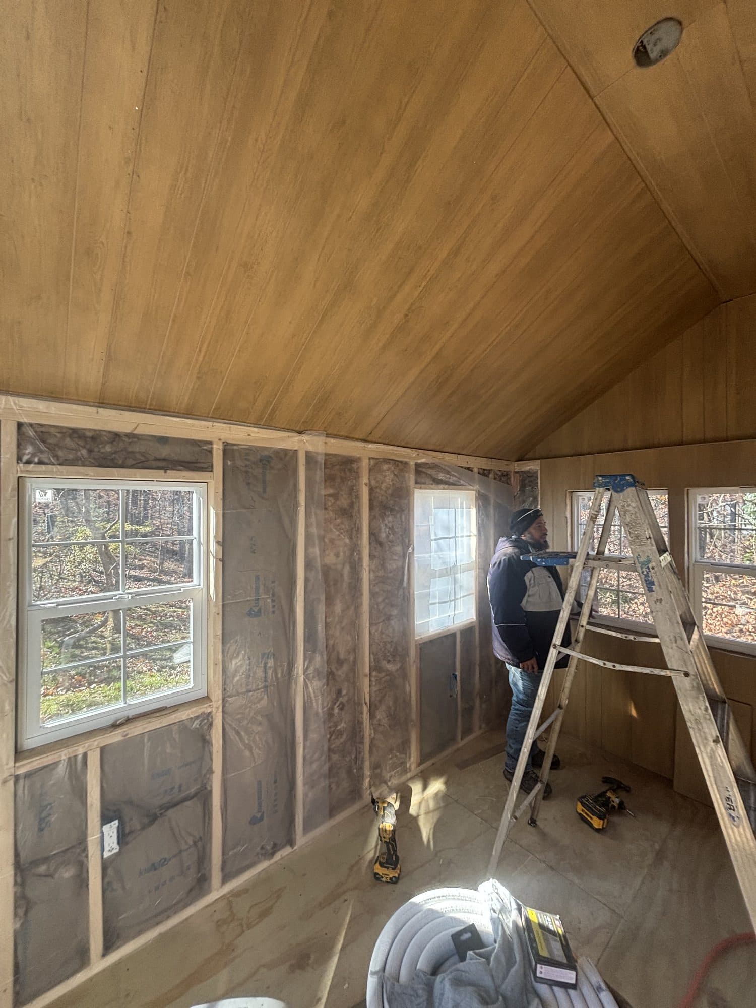Worker installing wood paneled interior of vault. Home addition project by Potts Brothers Construction, Arlington & Northern Virginia