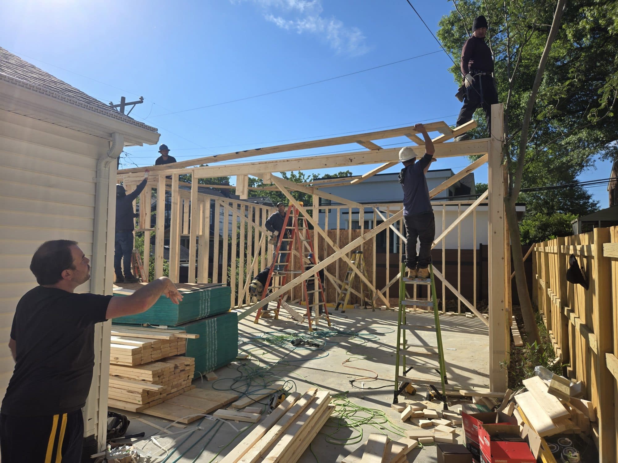 Workers framing wood addition walls. Home addition project by Potts Brothers Construction, Arlington & Northern Virginia