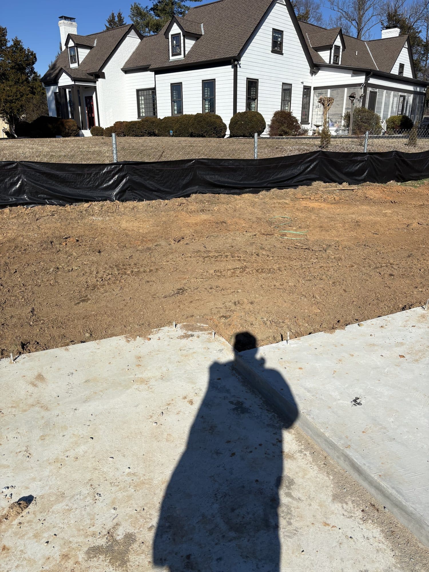 Concrete and graded yard before white home. Concrete project by Potts Brothers Construction, Arlington & Northern Virginia