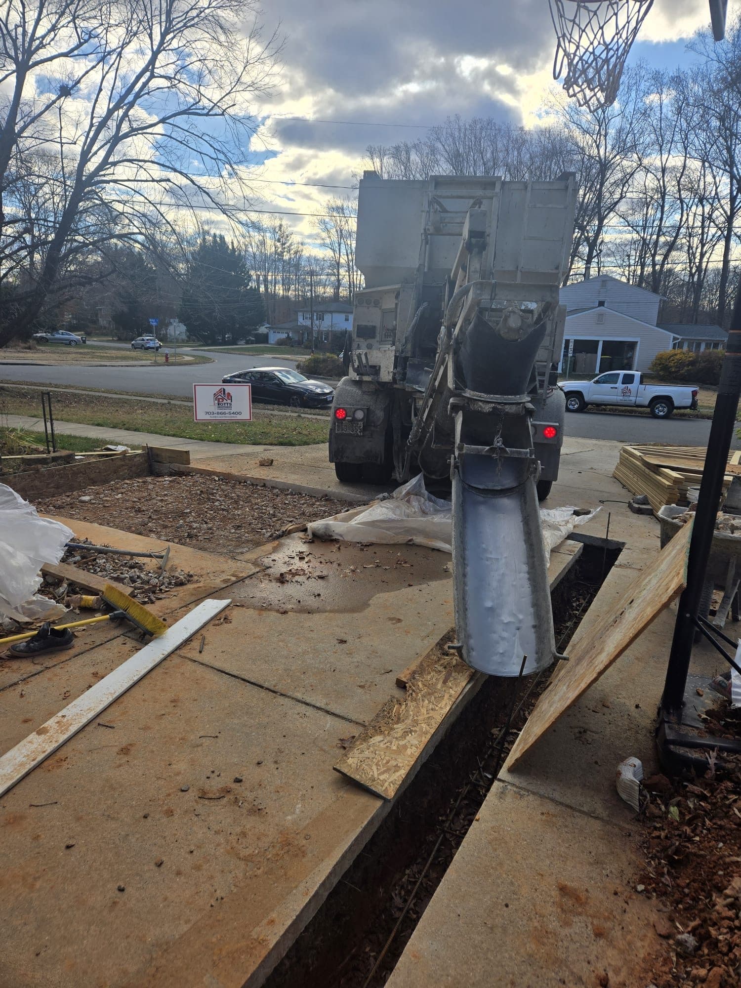 Concrete delivery truck chute pouring into footi. Concrete project by Potts Brothers Construction, Arlington & Northern Virginia