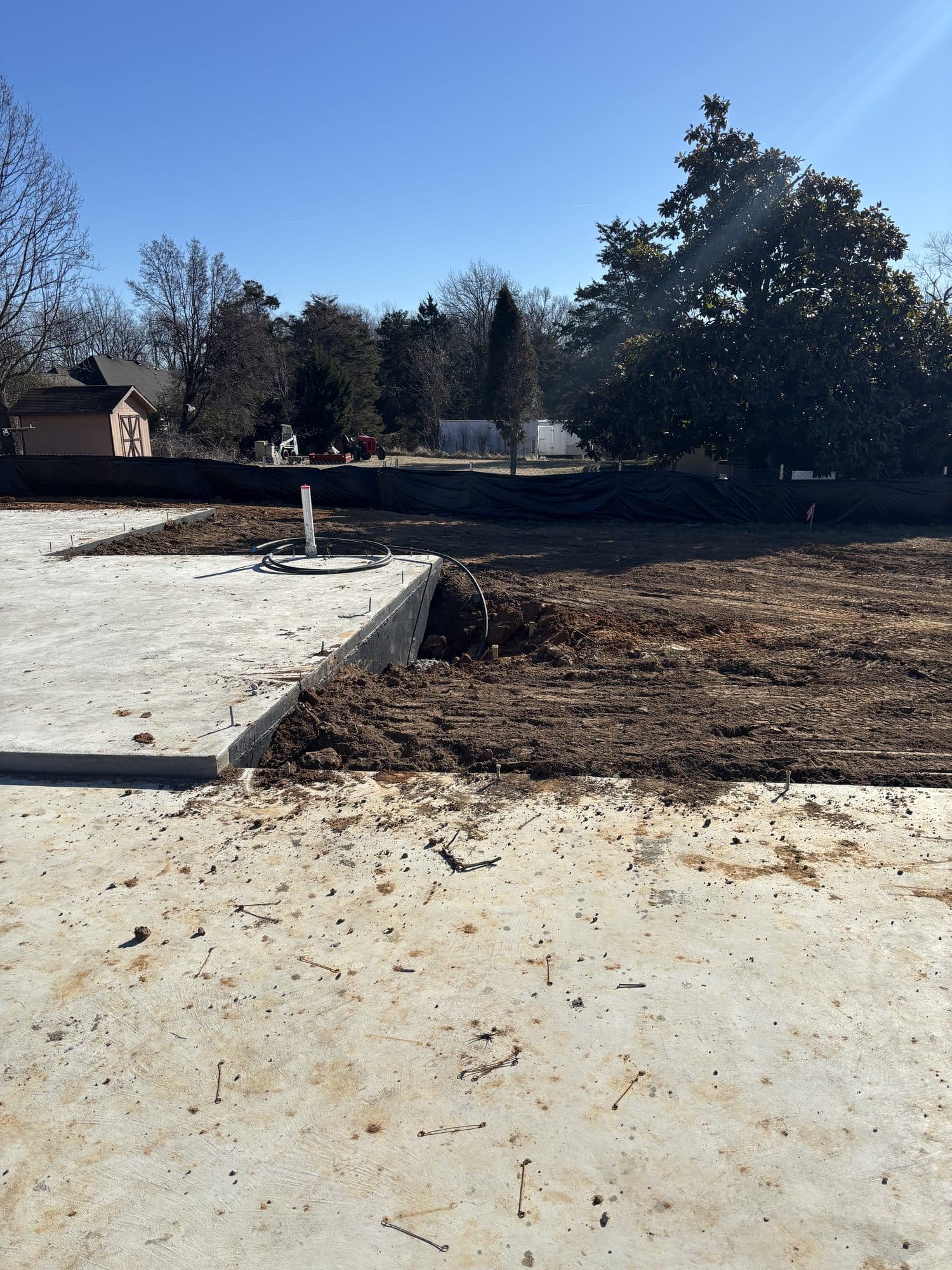 Concrete slab edge with graded dirt yard. Concrete project by Potts Brothers Construction, Arlington & Northern Virginia