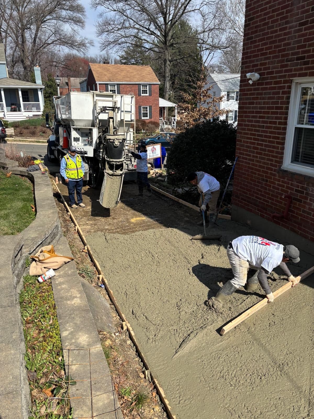 Crew pouring concrete mixer chute. Concrete project by Potts Brothers Construction, Arlington & Northern Virginia