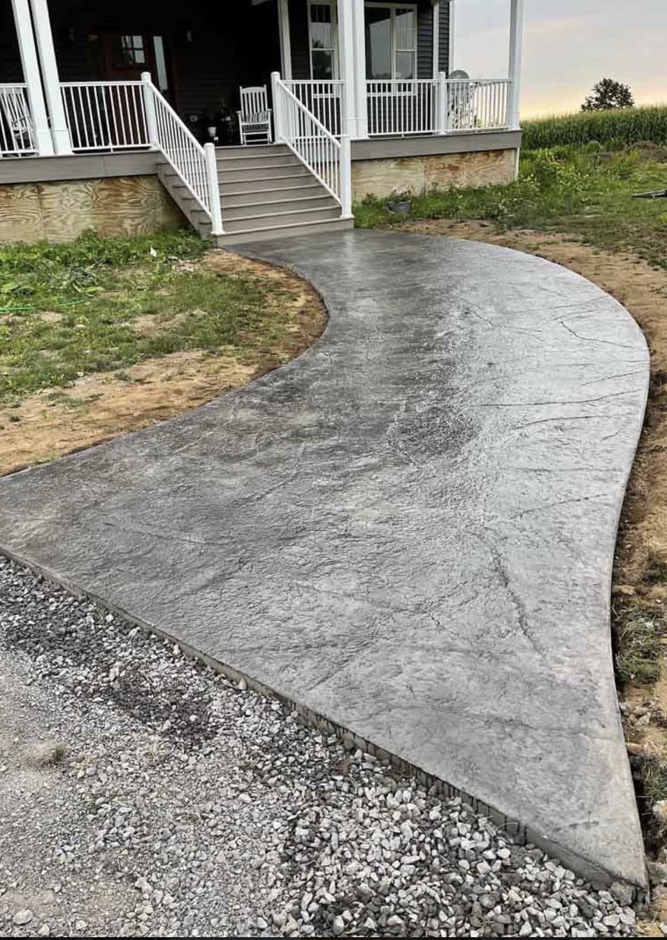 Curved stamped concrete walkway to home porch steps. Concrete project by Potts Brothers Construction, Arlington & Northern Virginia