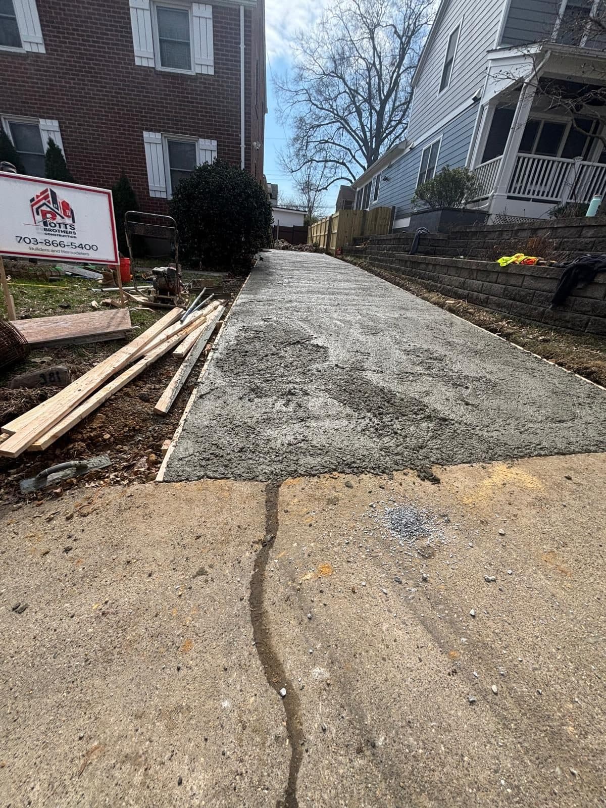 Freshly poured concrete walkway alongside. Concrete project by Potts Brothers Construction, Arlington & Northern Virginia