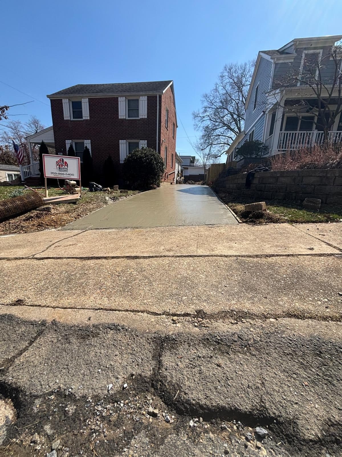 New concrete driveway leading brick. Concrete project by Potts Brothers Construction, Arlington & Northern Virginia
