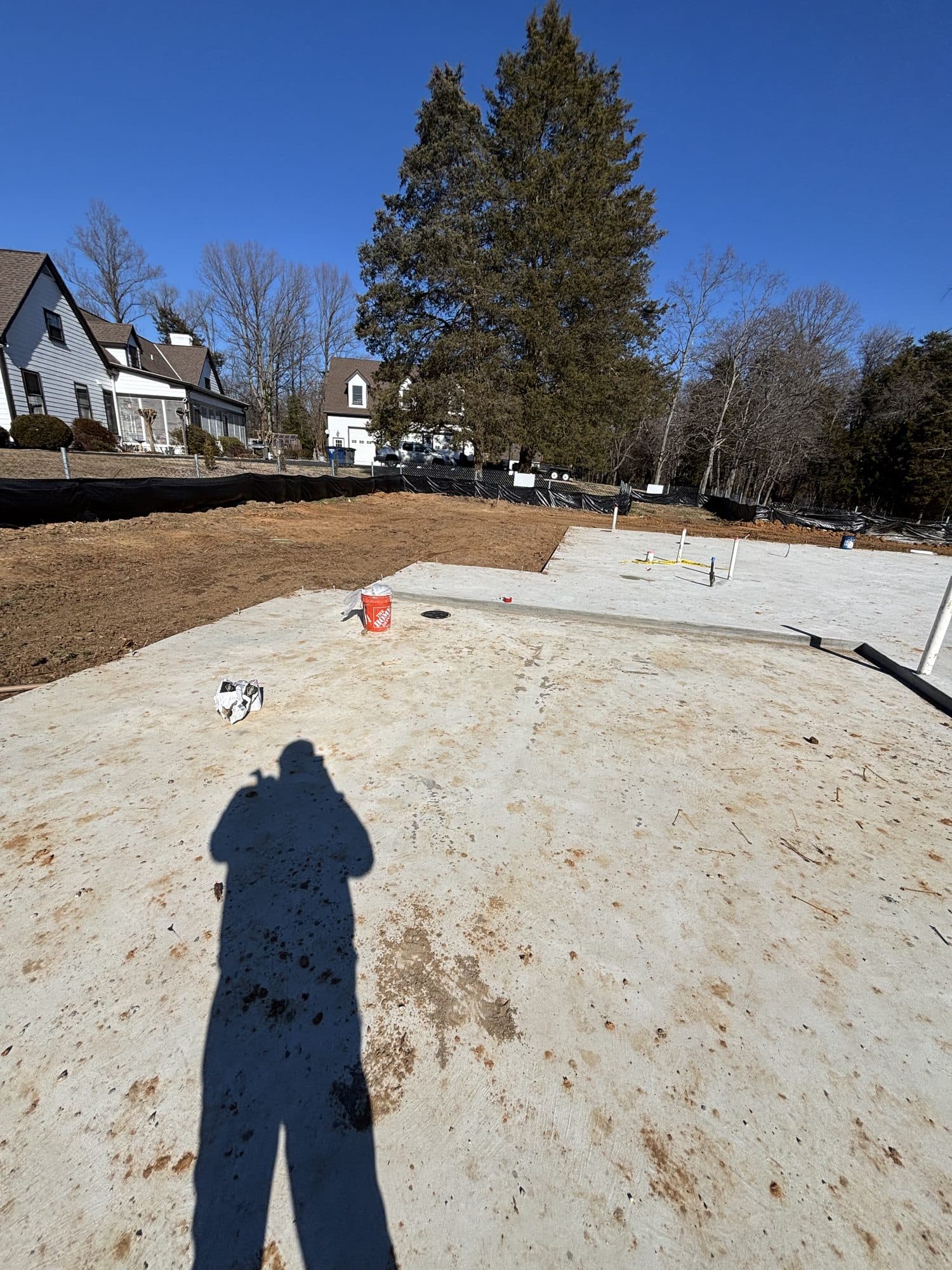 Poured concrete slab with house in background. Concrete project by Potts Brothers Construction, Arlington & Northern Virginia