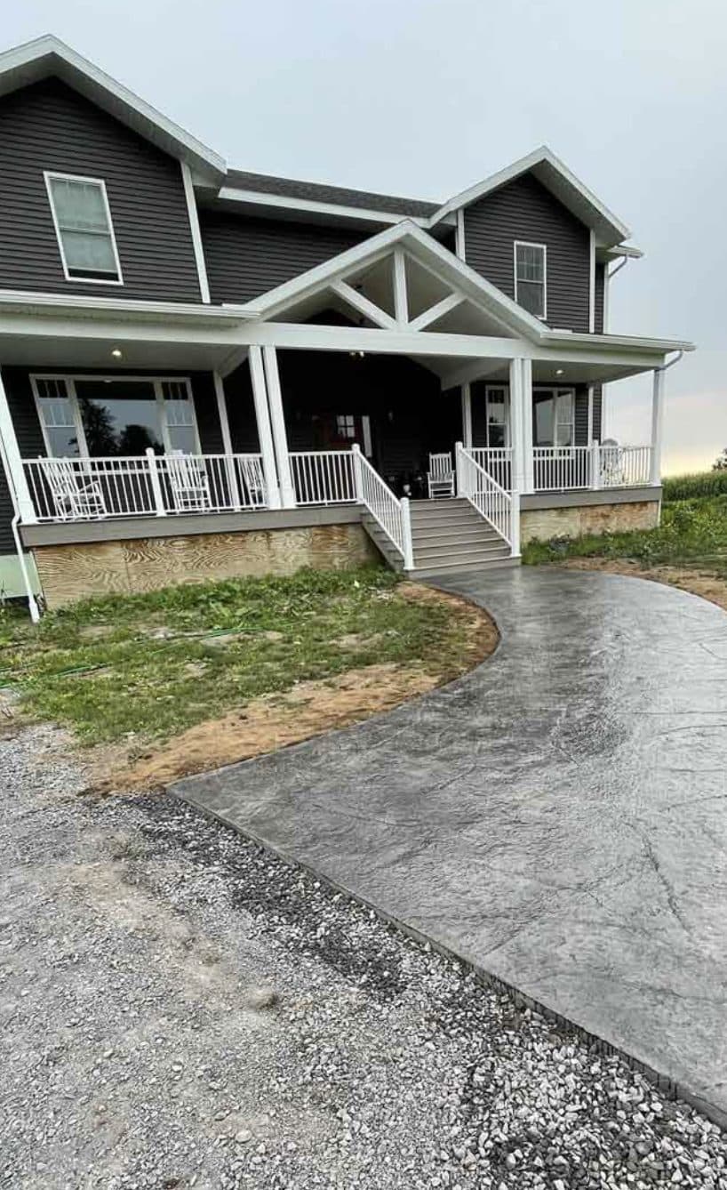 Stamped concrete driveway curving to covered front porch. Concrete project by Potts Brothers Construction, Arlington & Northern Virginia