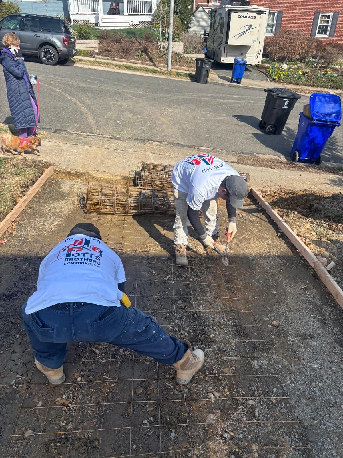 Two crew members tying rebar. Concrete project by Potts Brothers Construction, Arlington & Northern Virginia