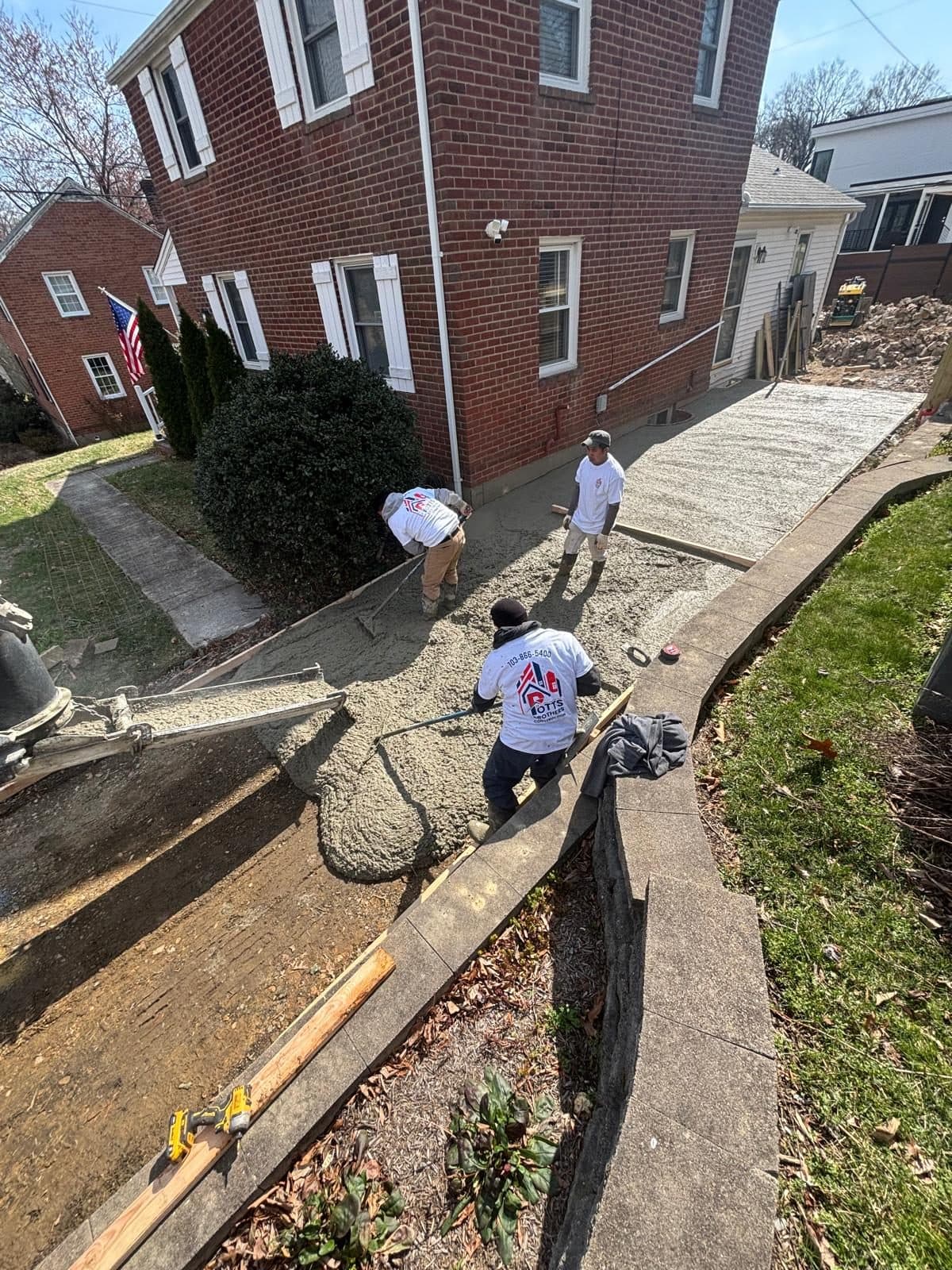 Workers placing concrete narrow side. Concrete project by Potts Brothers Construction, Arlington & Northern Virginia