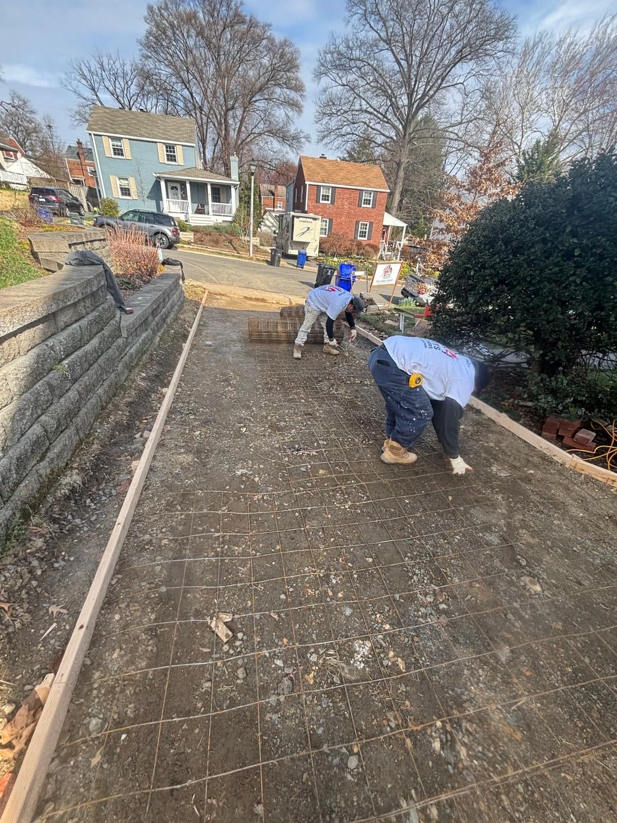 Workers preparing reinforced driveway slab. Concrete project by Potts Brothers Construction, Arlington & Northern Virginia