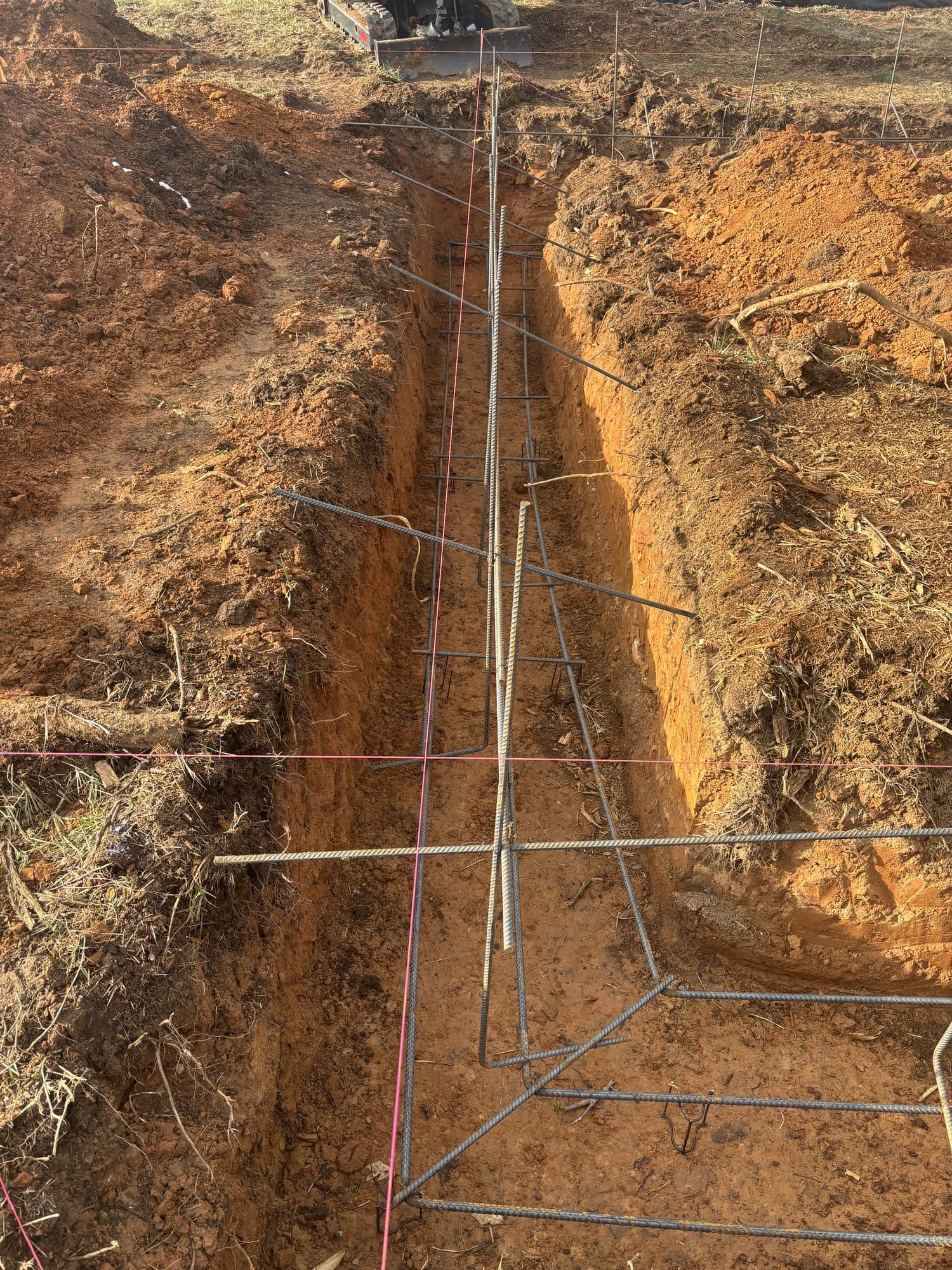 Excavated foundation with rebar and potts brothe. Foundation project by Potts Brothers Construction, Arlington & Northern Virginia
