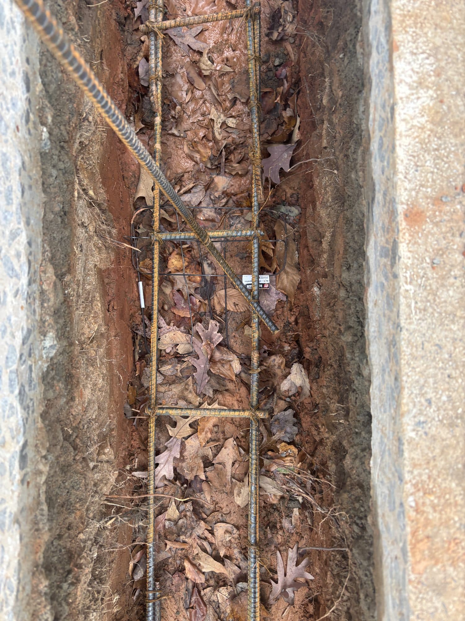 Footing trench with rebar reinforcement. Foundation project by Potts Brothers Construction, Arlington & Northern Virginia