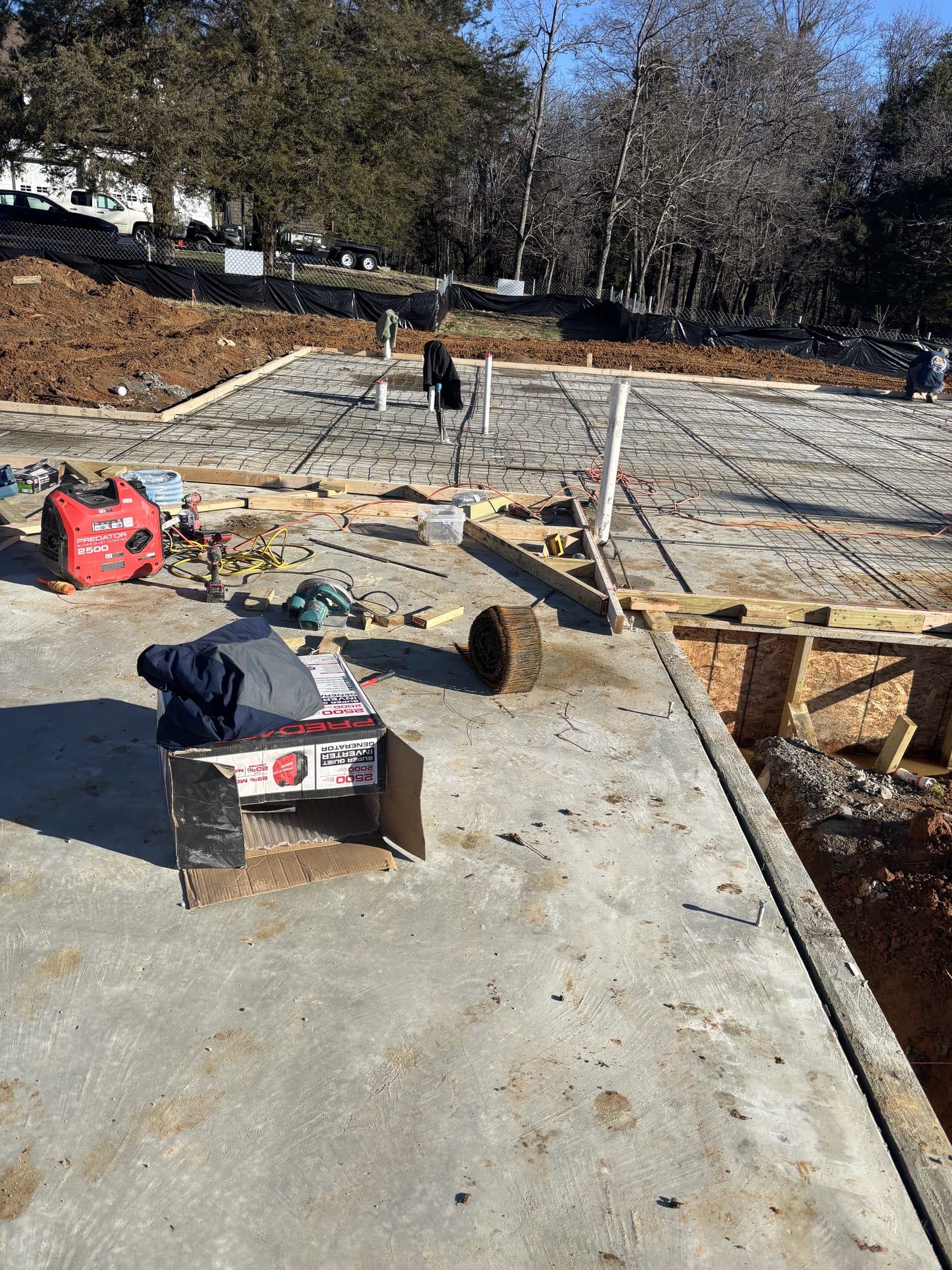 Slab pour with rebar mat and screed forms in sun. Foundation project by Potts Brothers Construction, Arlington & Northern Virginia