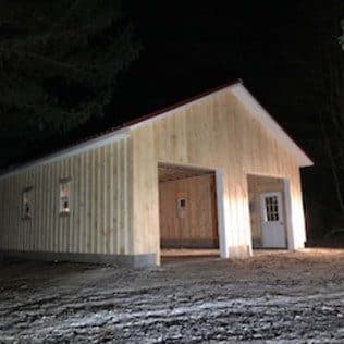 A newly built detached garage with board-and-batten siding and open bays. Garage project by Potts Brothers Construction, Arlington & Northern Virginia